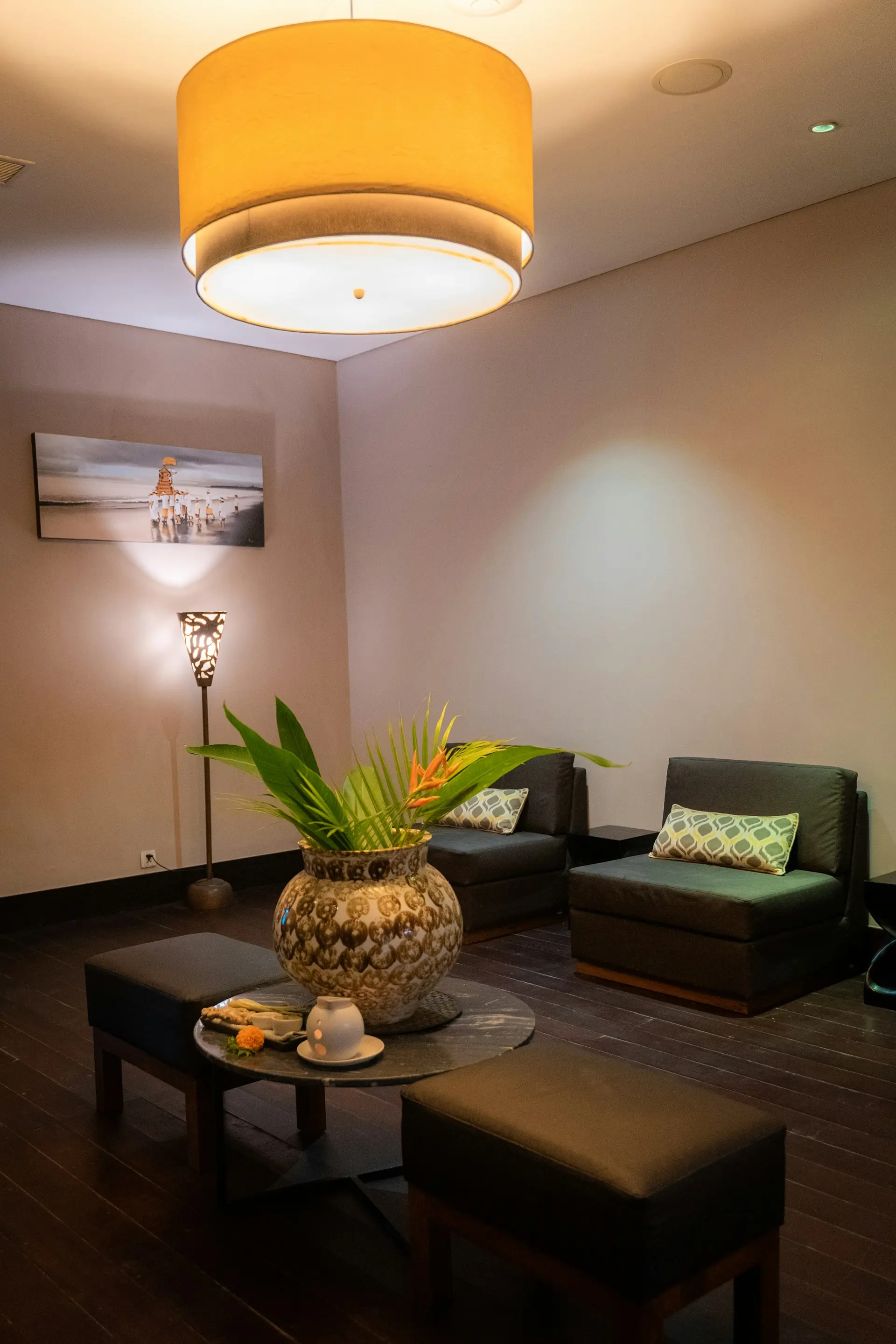 Warm, softly lit spa lounge with armchairs and plants
